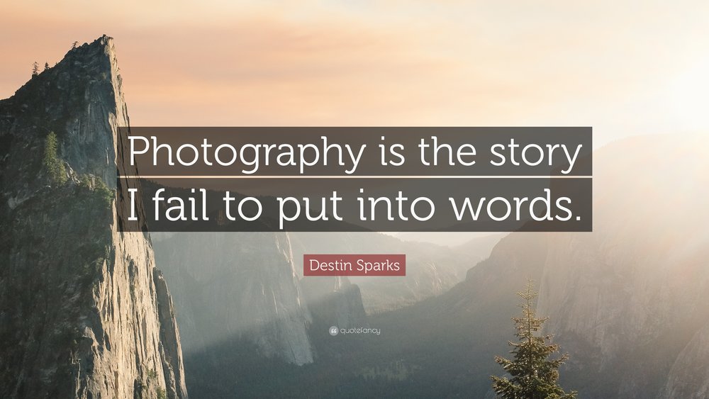 Text of quote ("Photography is the story I fail to put into words."), by Destin Sparks, overlaying large mountains and cliffs during morning sunrise.
