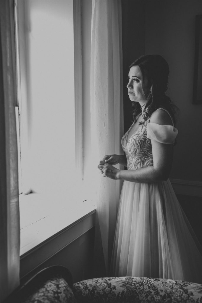black and white wedding bride portrait in front of window