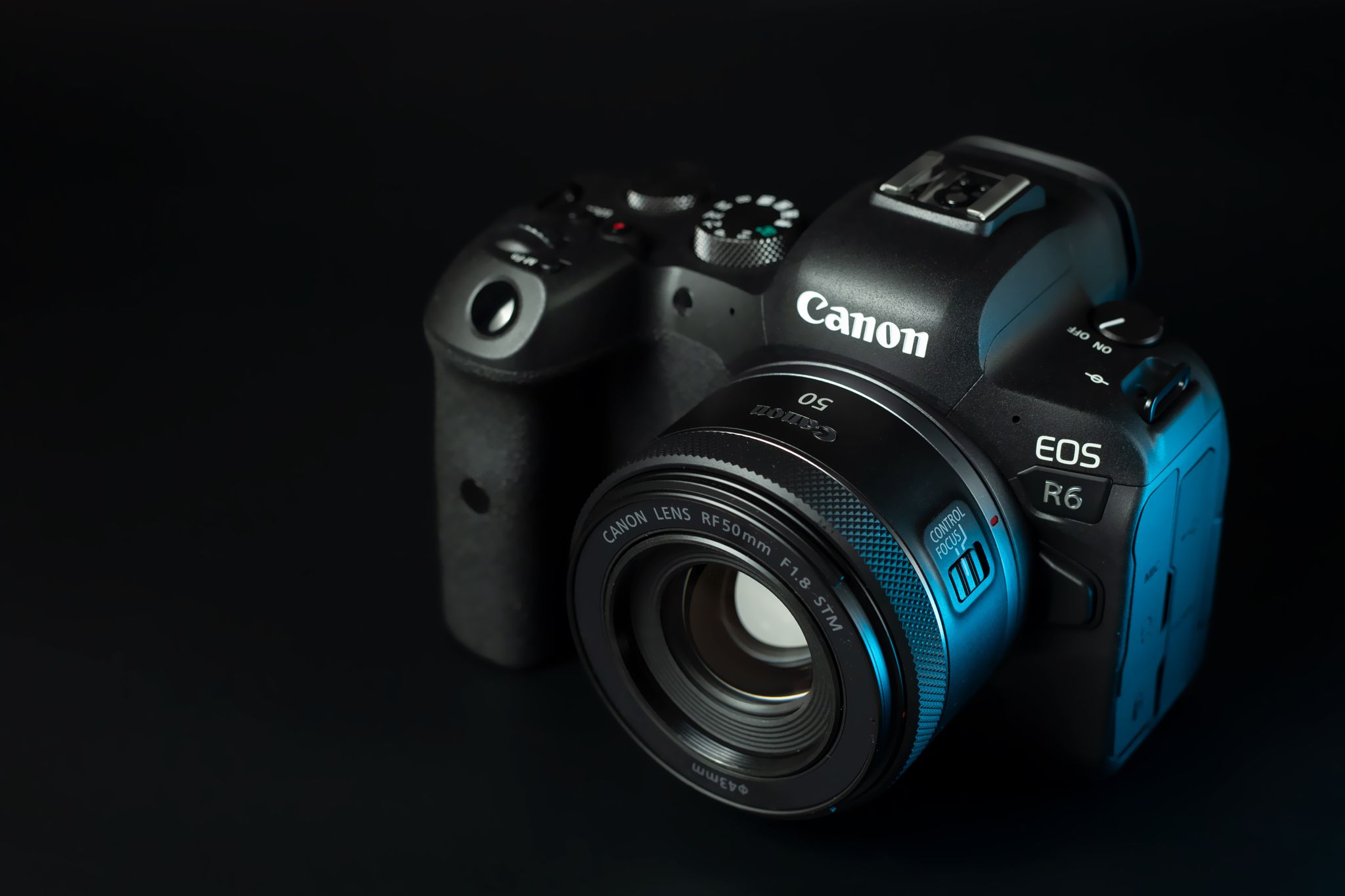 Close-up of a DSLR camera with lens highlighting its features on a black background.