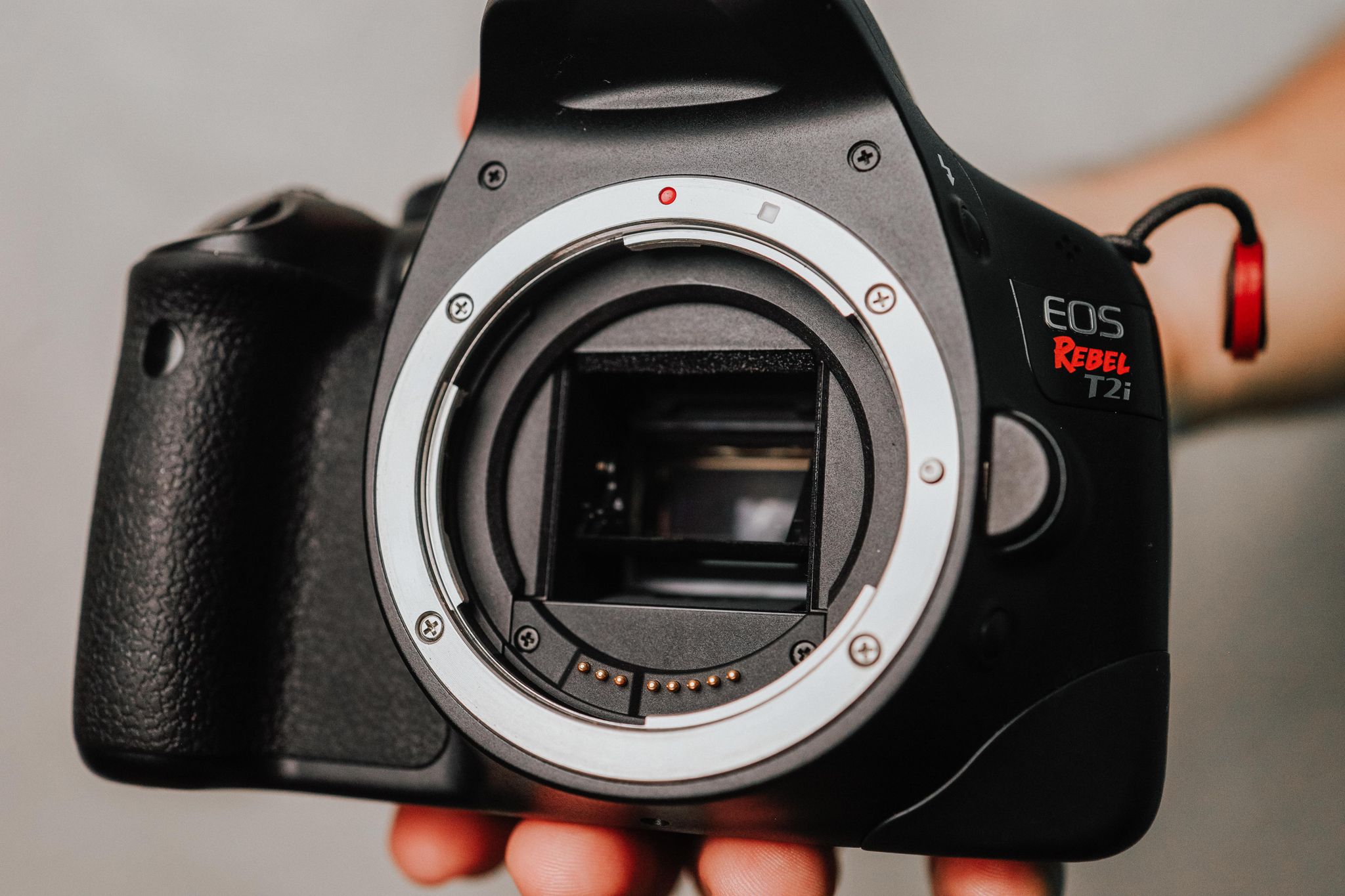 Detailed shot of a DSLR camera body without a lens, showcasing its design.